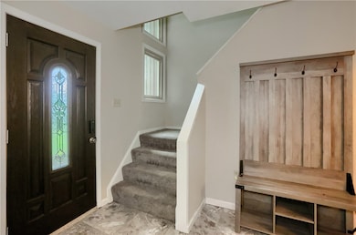 A beveled front door allows natural light to grace