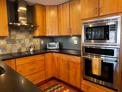 Beautiful kitchen featuring granite, tile and wood