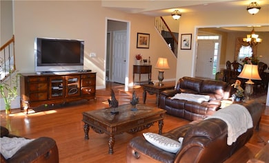 Living area featuring baseboards, wood finished fl
