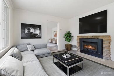 Living area off entry hall with gas fireplace - Virtually staged to provide a sense of size and uses