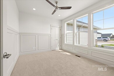 Spare room featuring a decorative wall, a ceiling fan, carpet, recessed lighting, and a wainscoted wall