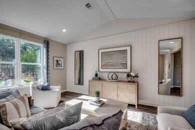 Living room with lofted ceiling and hardwood / wood-style floors