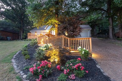 View of front of house featuring a wooden deck and