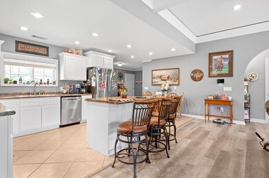 The open concept floor plan includes a spacious ea