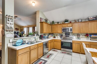 Kitchen featuring light tile patterned flooring, l