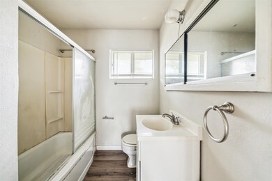 The bathroom features a functional layout with a t