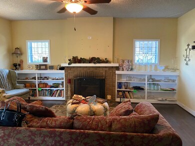 Living area featuring a fireplace, a textured ceil