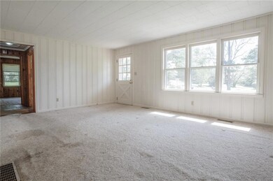 Carpeted spare room featuring visible vents