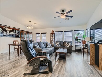 Living room w/ wood laminate flooring, ceiling fan