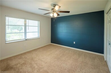 Empty room featuring ceiling fan and carpet