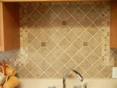 The Kitchen is accented by custom tile backsplash.