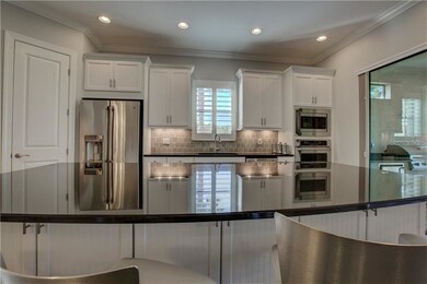Gorgeous Black granite with white cabinets creates