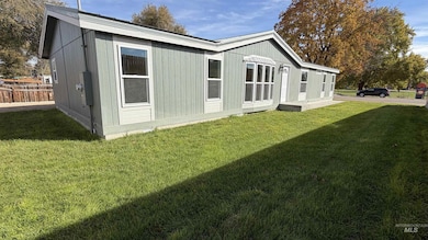 Rear view of property with a lawn