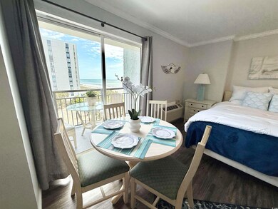 Bedroom featuring crown molding, a water view, acc
