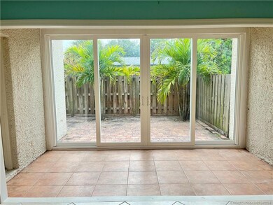 Sunroom with impact glass sliders leading to priva