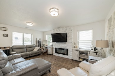 Living area with a fireplace and wood finished floors