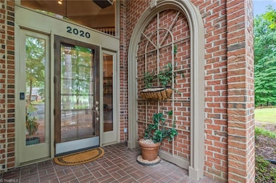 The use of large windows and a paned glass door allows for natural light to shine through.