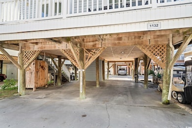 Garage featuring a carport