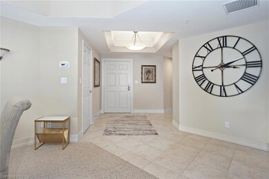 Entryway with ornamental molding, a tray ceiling, 