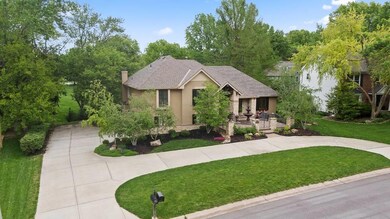 Side entry garage and lush landscape.