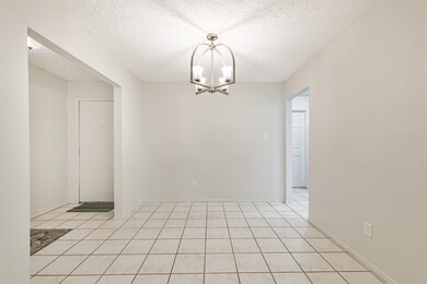 Formal dining room with attractive ceiling light.