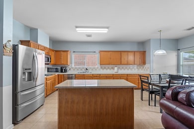 Spacious kitchen with island and breakfast area.