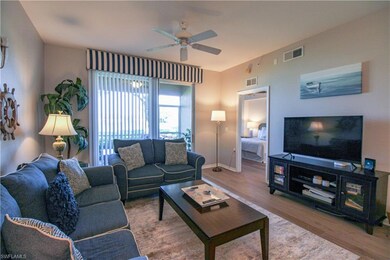 Living room with ceiling fan and hardwood / wood-s