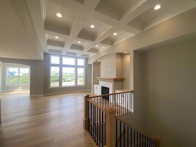 Stunning details throughout this villa! Arches, coffered ceiling, custom cabinets, gorgeous hardwood floors. And L.P. Smartside exterior siding. HOA snow removal and lawn care