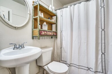Bathroom featuring walk in shower, sink, and toile