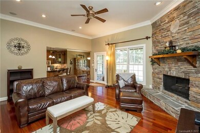 Great Room features stacked stone fireplace and en