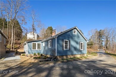 This is a perfect spot in West Asheville. You come down the drive off of Johnston Blvd. to join two other cute, cute homes and an artist studio. There is no thru road. It sits just below Johnston Blvd. for privacy and a sense of spaciousness.