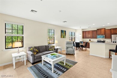 Living area with light tile patterned flooring and recessed lighting