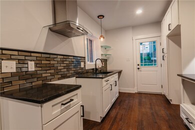 Metallic back splash, with matte black granite cou
