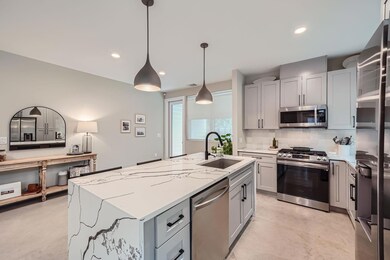 Kitchen featuring decorative backsplash, concrete