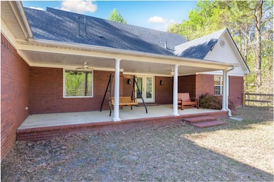 Back of house with roof with shingles, french door