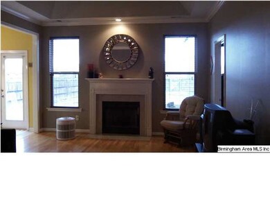 Family room features hardwoods, fireplace, trey ce