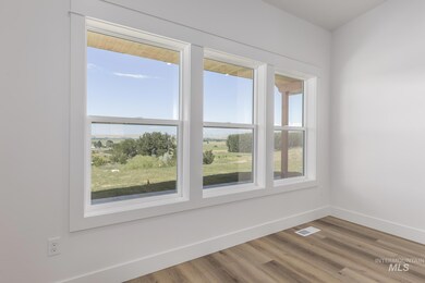Unfurnished room with baseboards and wood finished floors