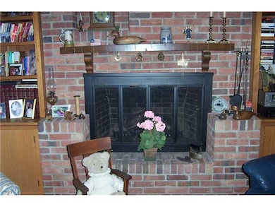 Family Room. Gas fireplace in brick wall with shel