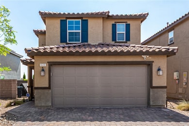 View of front facade with a garage, a tile roof, a