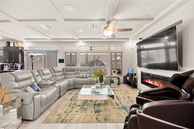 Living area featuring coffered ceiling, a ceiling