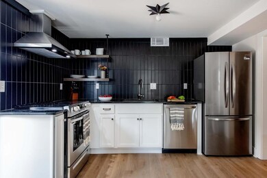 Kitchen featuring stainless steel appliances, whit