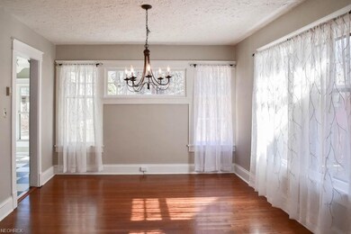 Formal dining room with wood flooring.
