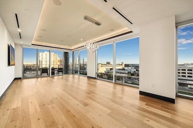 This corner condo in a luxury high-rise offers stu