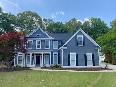 Traditional home with a front yard and a porch