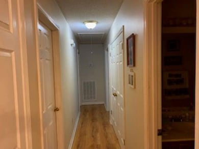Hall featuring visible vents, light wood-style flo