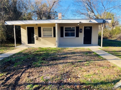 Bungalow with a front yard and stucco siding