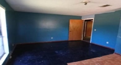 Spare room with plenty of natural light and baseboards