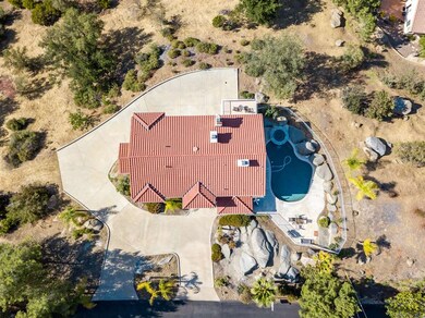 Aerial view of home and surrounding concrete.