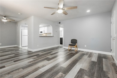 Living room with ceiling fan, wood finished floors