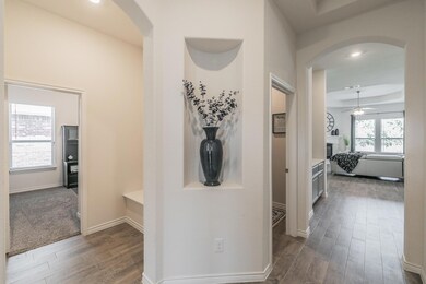 Hallway featuring dark wood-type flooring and a tr